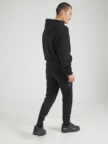 Nike Sportswear Zúžený strih Nohavice 'TCH FLC' - Čierna