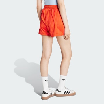 ADIDAS ORIGINALS Loose fit Trousers in Orange