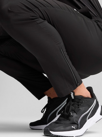 PUMA Tapered Sports trousers 'TAD Essentials' in Black